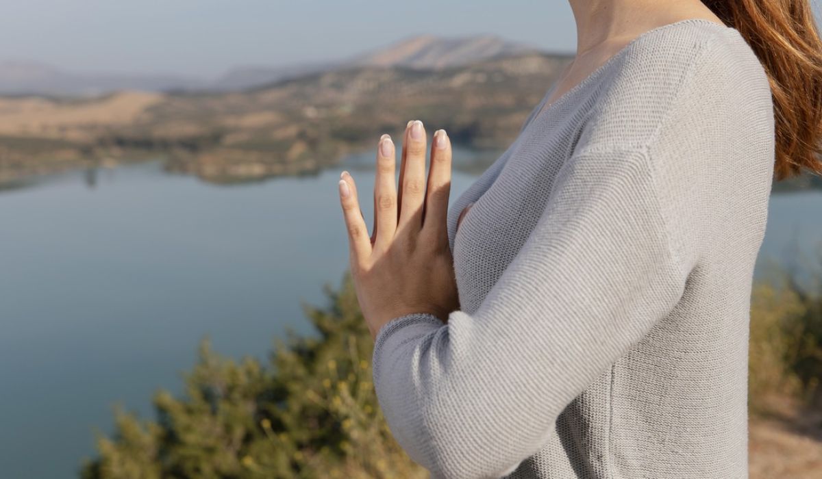 Side view woman meditating in nature